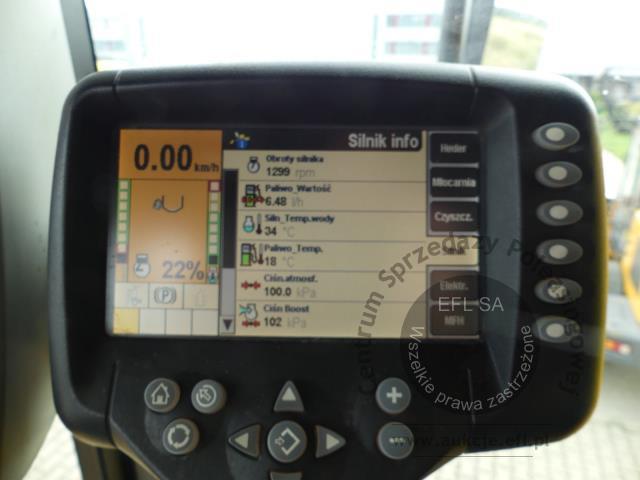 21 - EFL Finance Kombajn zbożowy New Holland CSX 7070 2009r. z hederem i wózkiem